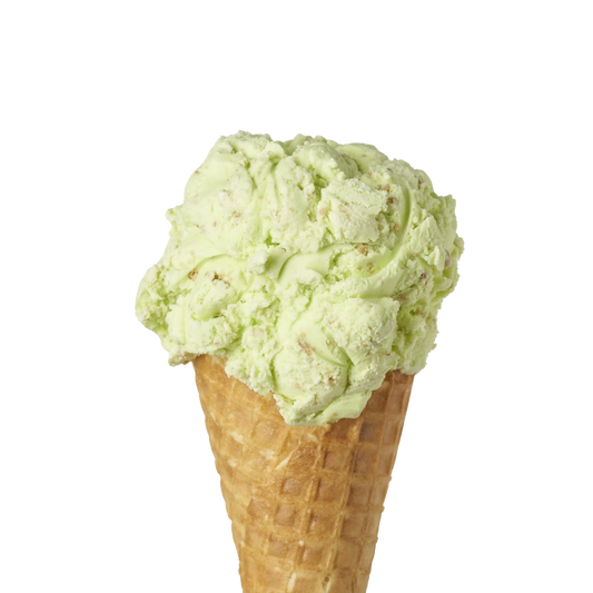 Green keylime pie fllavoured ice cream in a waffle cone on a white background
